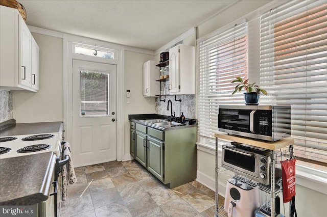 409 N Cherry St, Lancaster, PA 17602 - kitchen with stainless steel microwave, dark countertops, electric stove, and white cabinetry