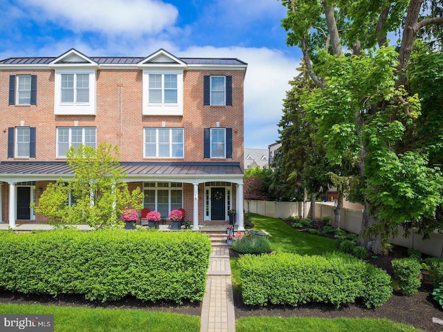 18 S Roberts Rd, Bryn Mawr, PA 19010 - view of front of home with a standing seam roof, a metal roof, brick siding, and a porch