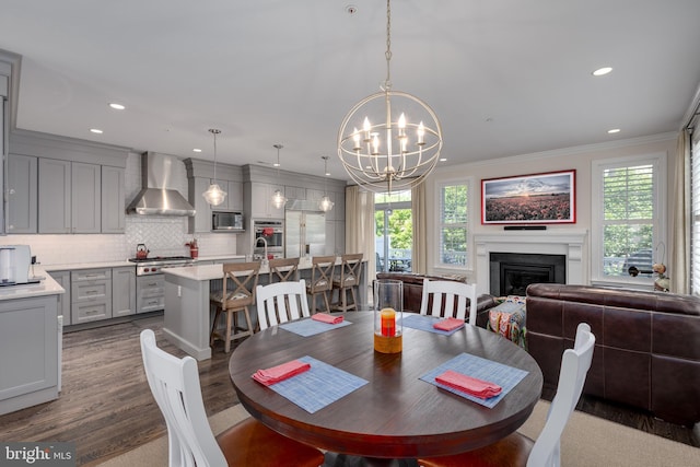 18 S Roberts Rd, Bryn Mawr, PA 19010 - dining room featuring a chandelier, a fireplace, crown molding, dark wood-type flooring, and recessed lighting