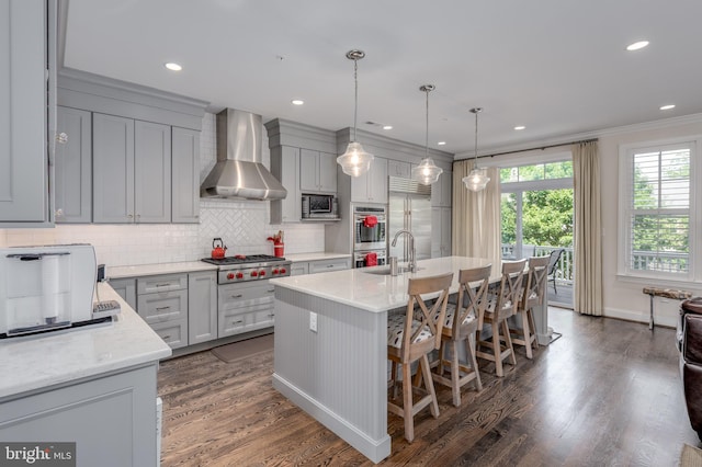 18 S Roberts Rd, Bryn Mawr, PA 19010 - kitchen with wall chimney exhaust hood, stainless steel appliances, ornamental molding, backsplash, and dark wood finished floors