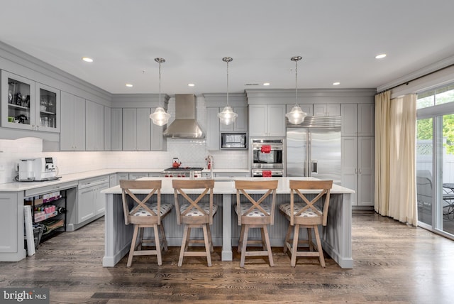 18 S Roberts Rd, Bryn Mawr, PA 19010 - kitchen featuring wall chimney exhaust hood, built in appliances, gray cabinets, tasteful backsplash, and recessed lighting