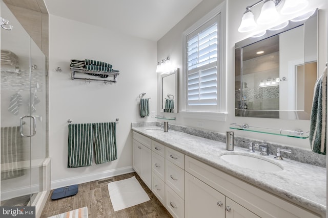18 S Roberts Rd, Bryn Mawr, PA 19010 - bathroom with double vanity, a stall shower, and wood finished floors
