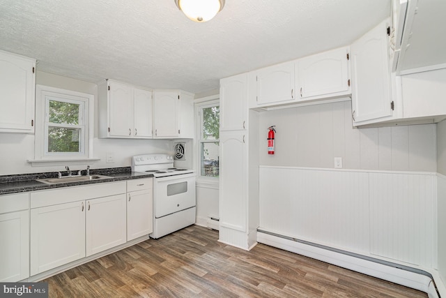 422 N High St, Duncannon, PA 17020 - kitchen featuring electric range, a baseboard radiator, white cabinetry, dark countertops, and a textured ceiling