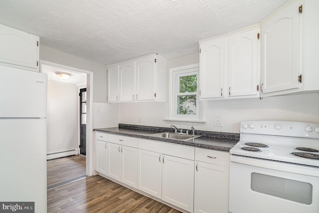 422 N High St, Duncannon, PA 17020 - kitchen with white appliances, baseboard heating, dark countertops, dark wood-style floors, and white cabinets