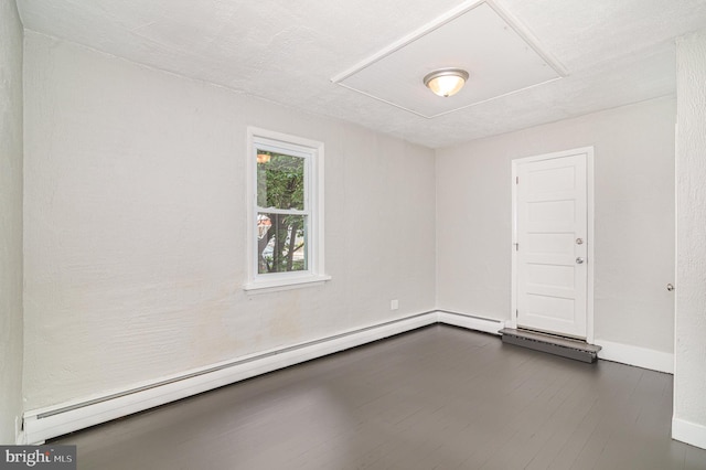 422 N High St, Duncannon, PA 17020 - unfurnished room with a baseboard heating unit and dark wood-type flooring