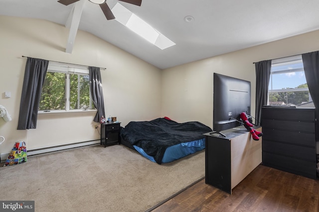 39 Roxeter Rd, New Castle, DE 19720 - bedroom featuring baseboard heating, vaulted ceiling, a skylight, multiple windows, and dark wood-type flooring