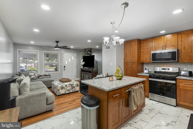 39 Roxeter Rd, New Castle, DE 19720 - kitchen with stainless steel appliances, open floor plan, light marble finish flooring, brown cabinetry, and recessed lighting