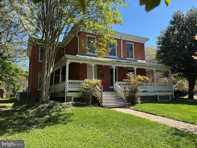 209 E Broad St, Falls Church, VA 22046 - view of front of house featuring brick siding, covered porch, and a front lawn