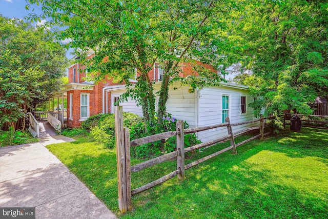 209 E Broad St, Falls Church, VA 22046 - view of property exterior featuring a garage and brick siding