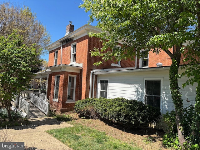 209 E Broad St, Falls Church, VA 22046 - rear view of property with brick siding and a chimney