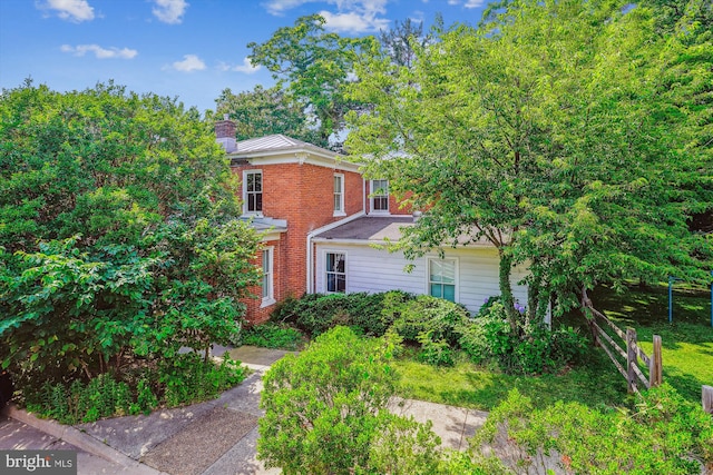 209 E Broad St, Falls Church, VA 22046 - view of front of house with a chimney and brick siding