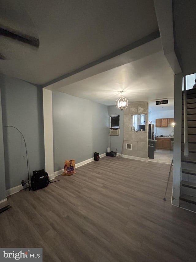 2446 N Bouvier St, Philadelphia, PA 19132 - unfurnished living room featuring wood finished floors, stairs, and a chandelier