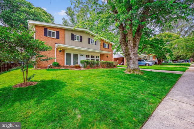 904 Hyde Rd, Silver Spring, MD 20902 - traditional-style home featuring a front lawn and brick siding