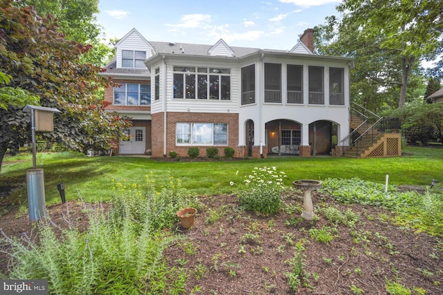 11203 Field Cir, Spotsylvania, VA 22551 - back of house with a sunroom, a chimney, brick siding, stairway, and a yard
