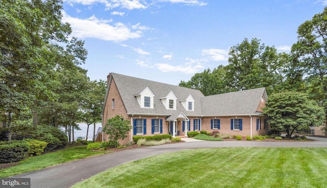 11203 Field Cir, Spotsylvania, VA 22551 - cape cod house with brick siding, a front yard, and driveway