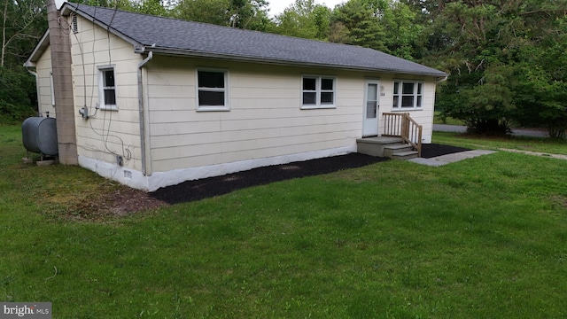 1414 Osborne Dr, Port Norris, NJ 08349 - view of front of property featuring oil tank, roof with shingles, and a front lawn