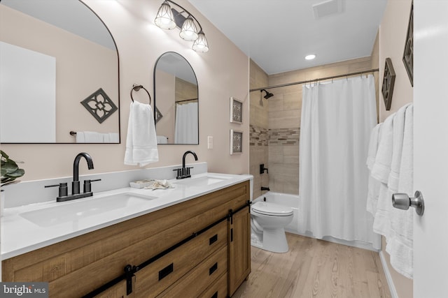 423 Highmeadow Rd, Reisterstown, MD 21136 - bathroom with double vanity, wood finished floors, and shower / tub combo with curtain