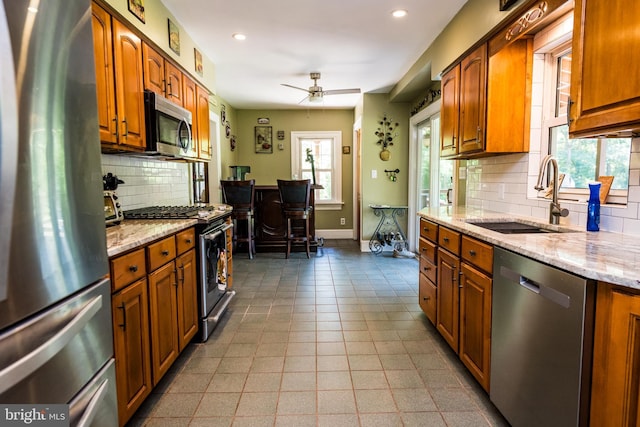 674 Good Intent Rd, Blackwood, NJ 08012 - kitchen featuring appliances with stainless steel finishes, plenty of natural light, brown cabinets, tasteful backsplash, and recessed lighting