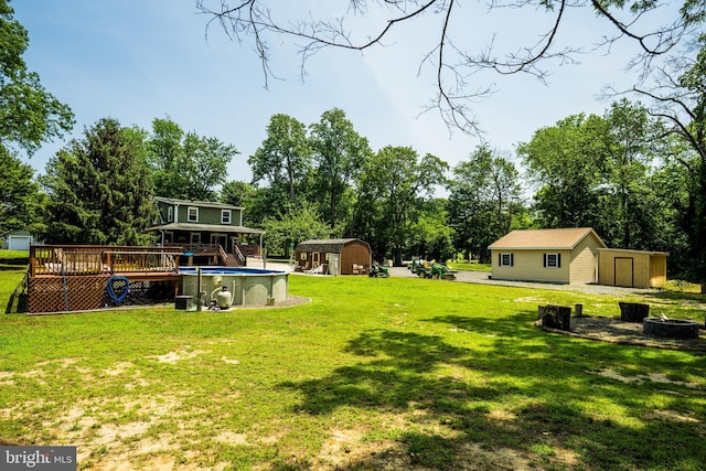 674 Good Intent Rd, Blackwood, NJ 08012 - view of grassy yard with a storage shed, a deck, a fire pit, an outdoor pool, and view of scattered trees