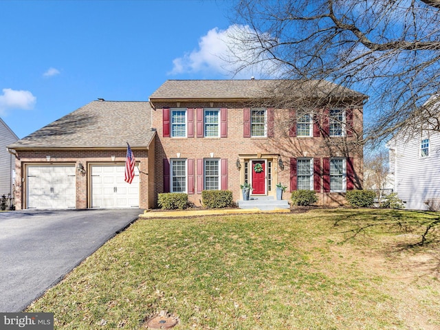 6108 Fieldcrest Dr, Frederick, MD 21701 - colonial house with brick siding, asphalt driveway, an attached garage, a front yard, and a shingled roof