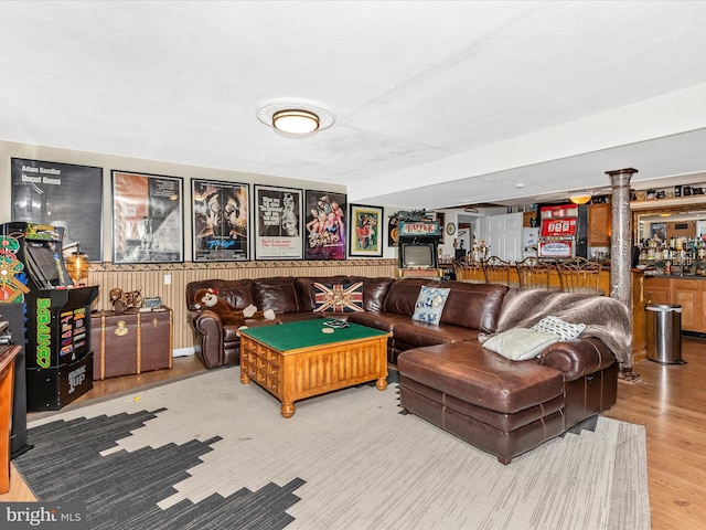 6108 Fieldcrest Dr, Frederick, MD 21701 - recreation room featuring decorative columns, wood finished floors, a wainscoted wall, bar area, and wooden walls