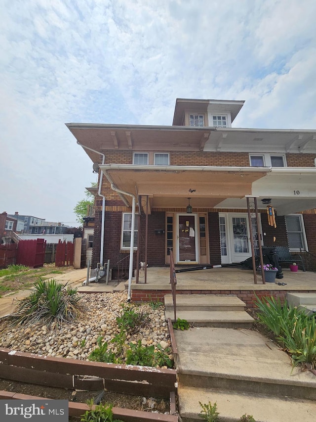 8 N Clinton St, York, PA 17404 - view of property featuring brick siding and covered porch