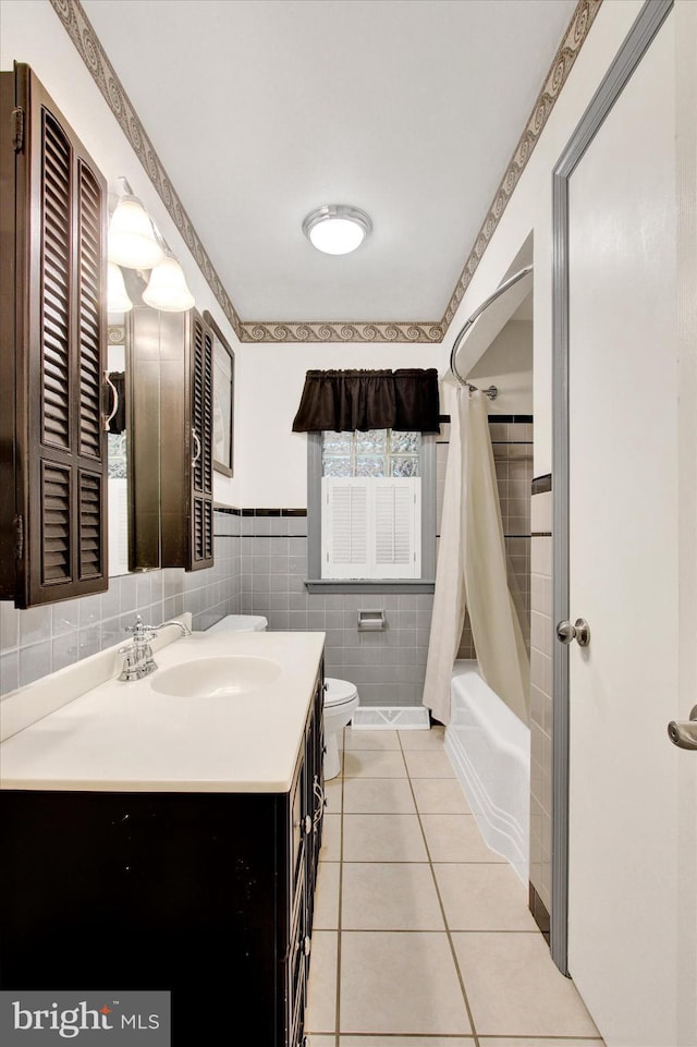 106 Mumma Ave, Hanover, PA 17331 - bathroom featuring vanity, tile patterned flooring, shower / bathtub combination with curtain, and tile walls