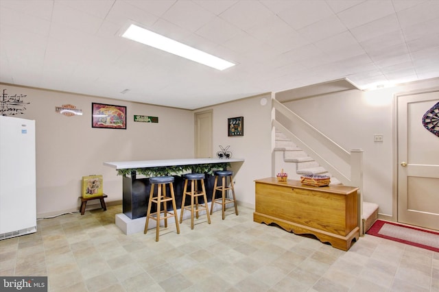 106 Mumma Ave, Hanover, PA 17331 - indoor dry bar with freestanding refrigerator, stairs, and light floors