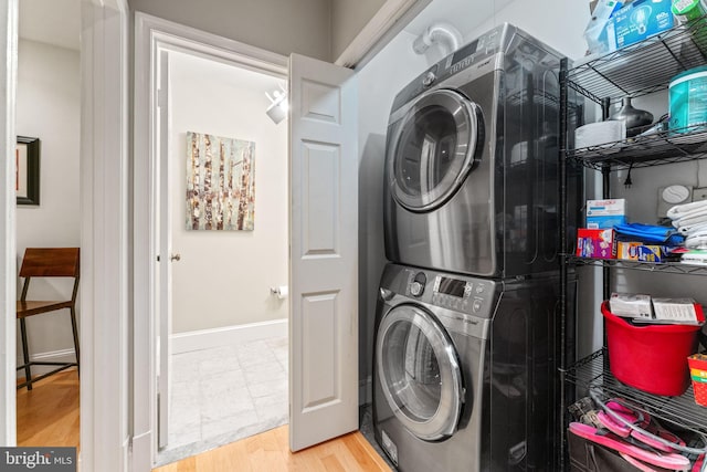 1618 Belmont St NW Unit D, Washington, DC 20009 - washroom featuring stacked washer / dryer and wood finished floors