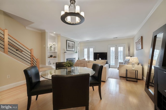 1618 Belmont St NW Unit D, Washington, DC 20009 - dining space with ornamental molding, french doors, a chandelier, stairway, and a fireplace