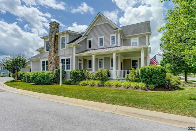 772 Golf View Dr, Crozet, VA 22932 - view of front of home with board and batten siding, a porch, a standing seam roof, a chimney, and a front lawn