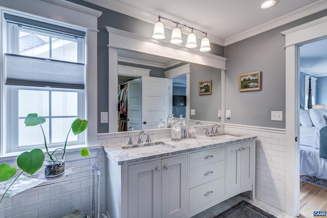 772 Golf View Dr, Crozet, VA 22932 - ensuite bathroom with tile walls, a wainscoted wall, double vanity, plenty of natural light, and ornamental molding
