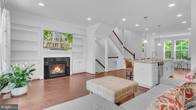 904 Joseph Johnson Dr, Annapolis, MD 21401 - living room with recessed lighting, built in features, ornamental molding, dark wood-type flooring, and stairs