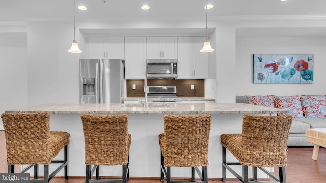 904 Joseph Johnson Dr, Annapolis, MD 21401 - kitchen featuring stainless steel appliances, tasteful backsplash, white cabinetry, crown molding, and decorative light fixtures