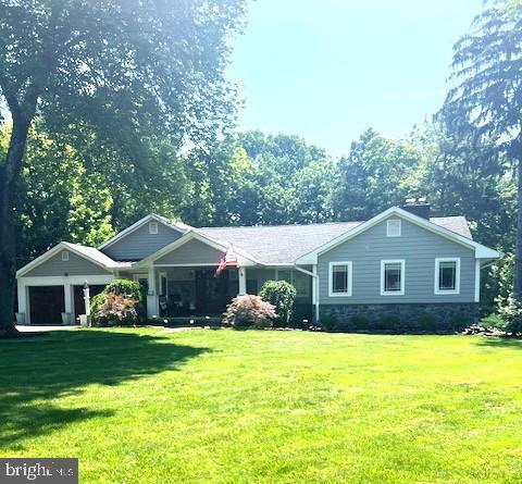 65 Shady Brook Ln, Princeton, NJ 08540 - view of front facade featuring a garage and a front yard