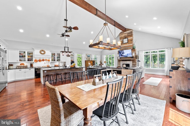 65 Shady Brook Ln, Princeton, NJ 08540 - dining room featuring high vaulted ceiling, light wood-style flooring, beamed ceiling, a fireplace, and a chandelier