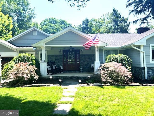 65 Shady Brook Ln, Princeton, NJ 08540 - view of front of house featuring a porch, a front lawn, and stone siding