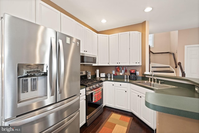 25336 Ripleys Field Dr, Chantilly, VA 20152 - kitchen with appliances with stainless steel finishes, dark countertops, dark wood-type flooring, white cabinets, and recessed lighting