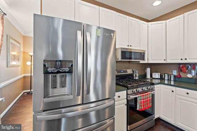 25336 Ripleys Field Dr, Chantilly, VA 20152 - kitchen featuring appliances with stainless steel finishes, dark countertops, dark wood-type flooring, white cabinets, and recessed lighting