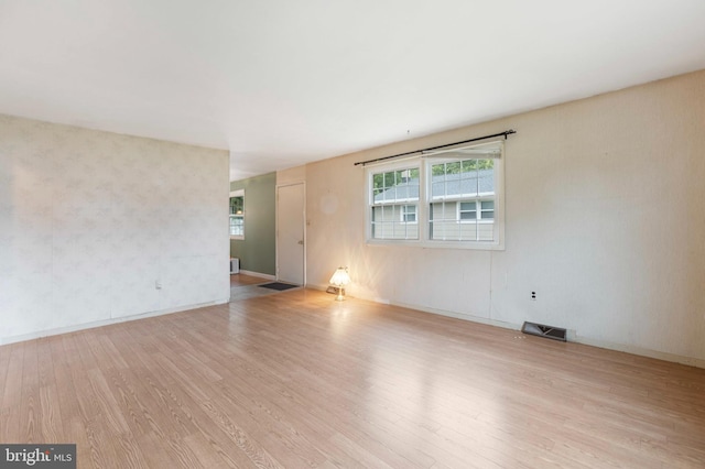 21 Jerrys Ave, Clayton, NJ 08312 - empty room with wood finished floors, wallpapered walls, and healthy amount of natural light