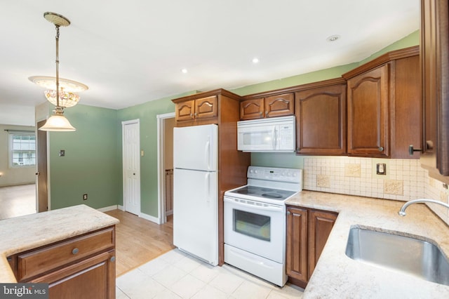 21 Jerrys Ave, Clayton, NJ 08312 - kitchen featuring white appliances, decorative light fixtures, decorative backsplash, light stone counters, and brown cabinetry