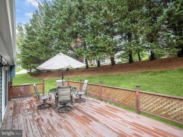 6250 Fairbourne Ct, Hanover, MD 21076 - wooden deck with outdoor dining area and a yard