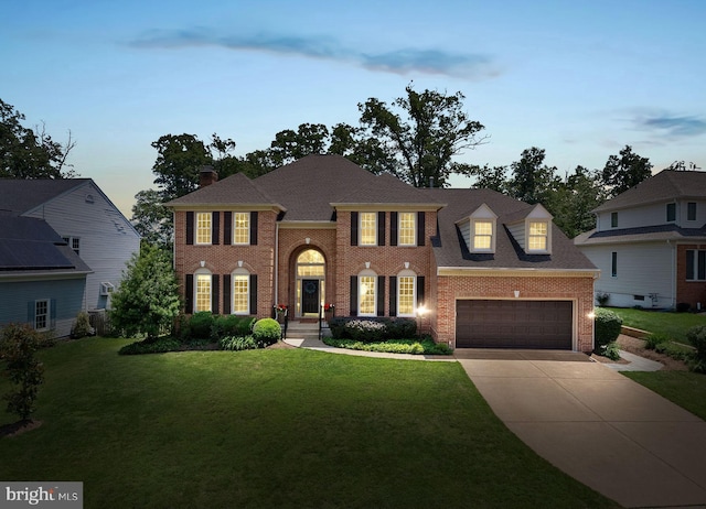 43251 Brownstone Ct, Ashburn, VA 20147 - colonial inspired home with brick siding, concrete driveway, a front yard, and a garage