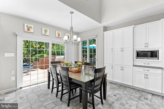 43251 Brownstone Ct, Ashburn, VA 20147 - dining room featuring a chandelier and light floors