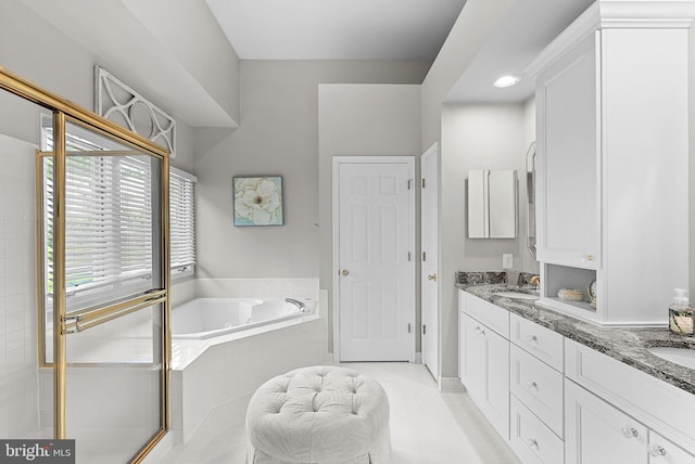 43251 Brownstone Ct, Ashburn, VA 20147 - full bath with a garden tub, double vanity, and tile patterned flooring