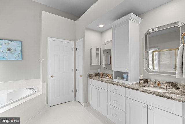 43251 Brownstone Ct, Ashburn, VA 20147 - full bathroom featuring double vanity, a garden tub, and tile patterned floors