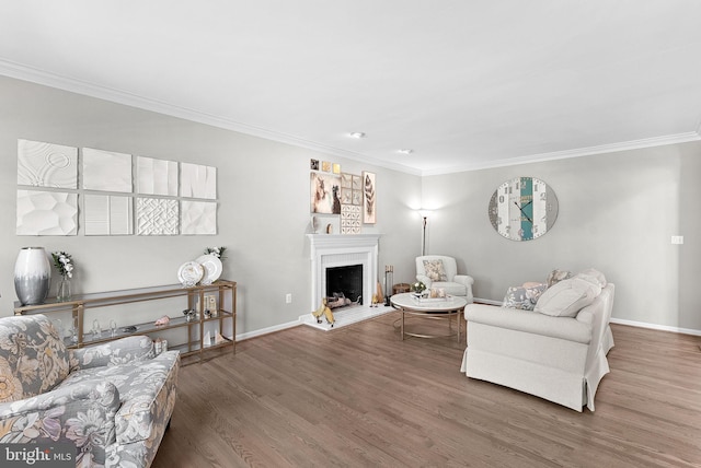 43251 Brownstone Ct, Ashburn, VA 20147 - living area with crown molding, wood finished floors, and a fireplace with raised hearth