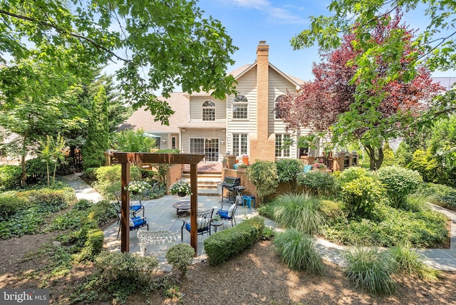 43251 Brownstone Ct, Ashburn, VA 20147 - back of house featuring a patio area and a wooden deck