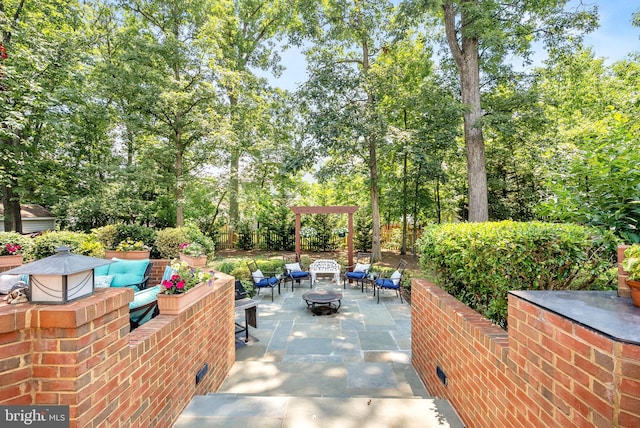 43251 Brownstone Ct, Ashburn, VA 20147 - view of patio with an outdoor living space with a fire pit