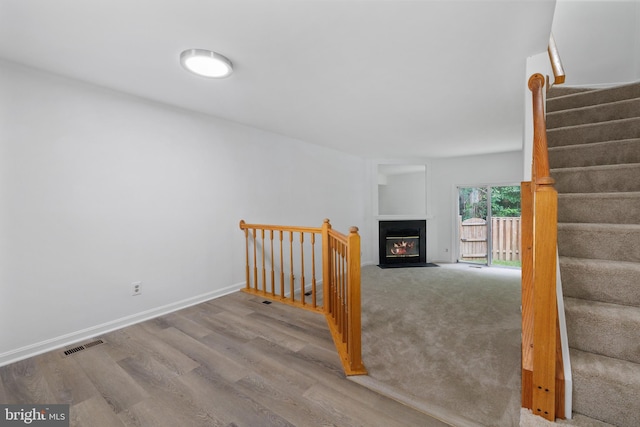 5840 Wescott Hills Way, Alexandria, VA 22315 - stairs with wood finished floors and a fireplace with flush hearth